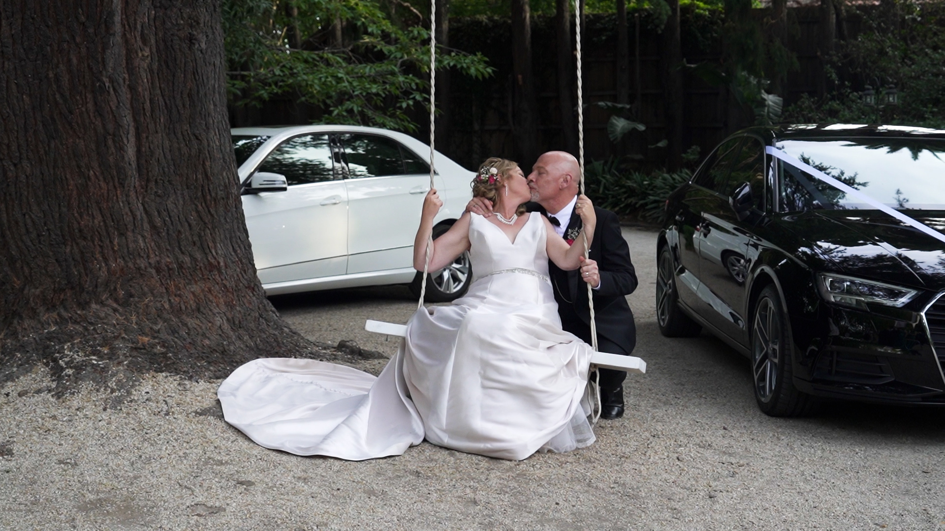 wedding video couple kissing on a swing